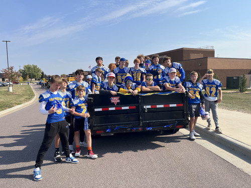 Olson Middle School Football Team poses for a picture during the 2024 Homecoming Parade.