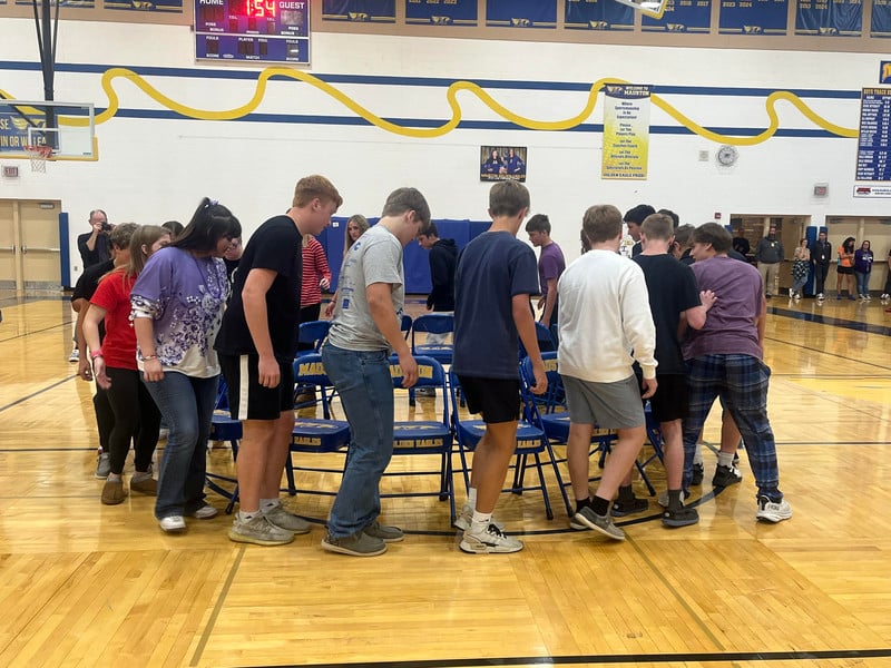 Homecoming student assembly in a round of musical chairs.