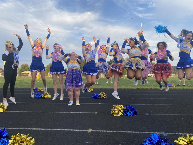 MHS Varsity Football Cheerleaders jumping for the picture.