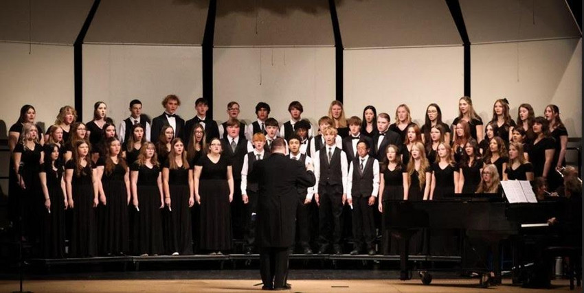 Mr. Pechman leads the choir at a holiday concert.