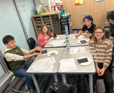 Students explored worm experiments in a classroom.