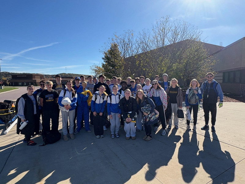 Cross Country team poses for a picture outside the schools.